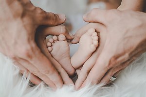 Gentle Touch Reflexology for babies and children . baby foot in heart hands